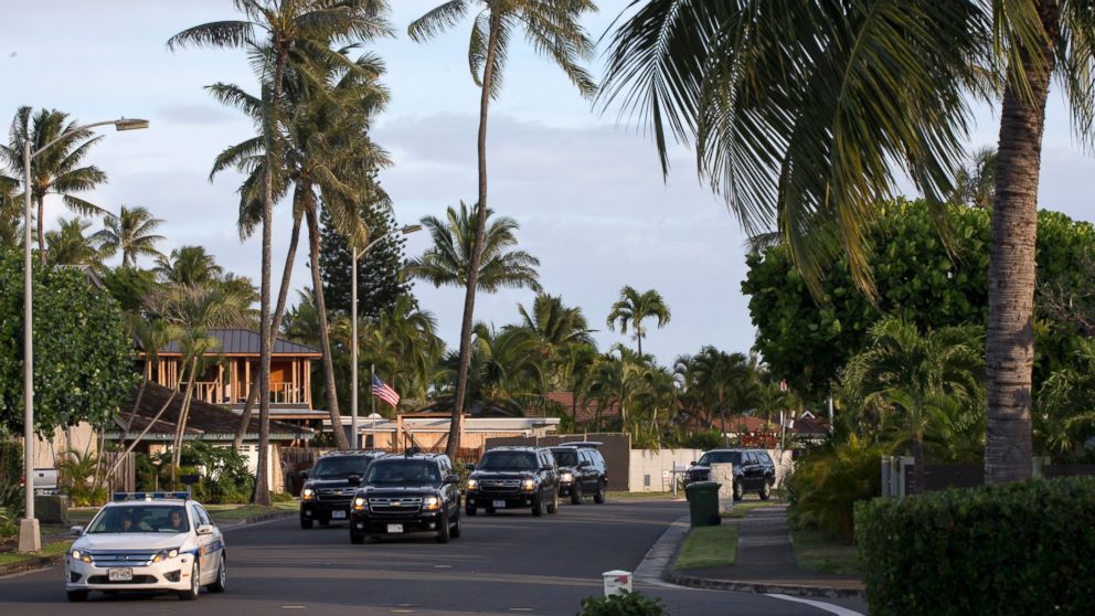 The motorcade carrying President Obama drives to the gym on Dec. 31, 2014, from his rental home in Kailua, Hawaii, during the Obama family vacation. 