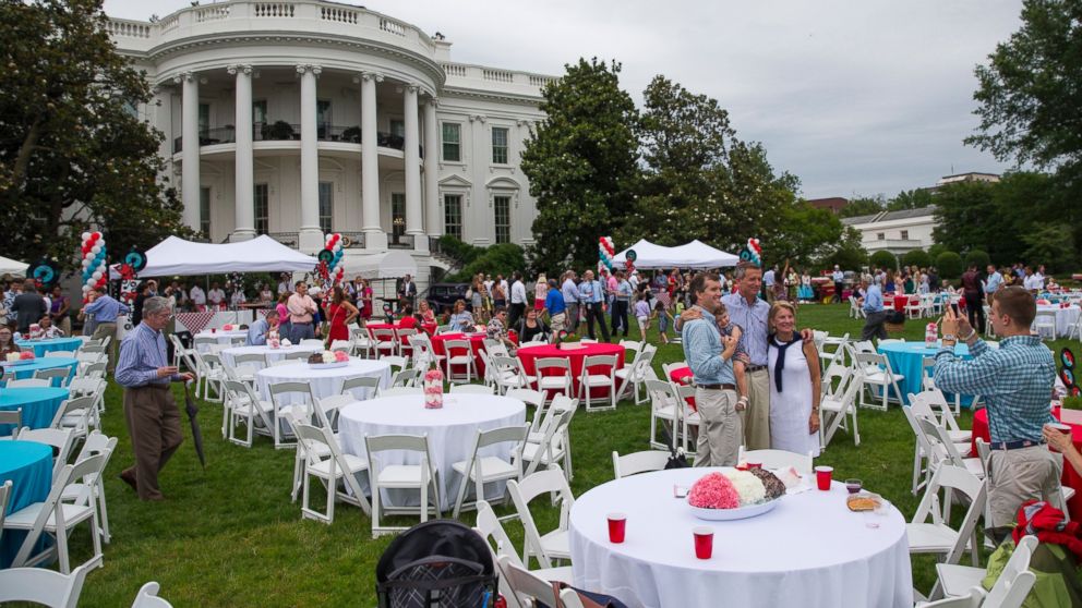 Guests take photos during a picnic for members of Congress on the South Lawn of the White House, June 17, 2015, in Washington.  