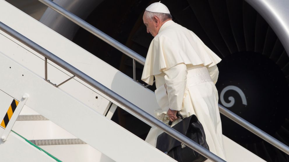 PHOTO:Pope Francis carries his work bag in Rome's Fiumicino International airport, July 5, 2015, as he boards his flight to Quito, Ecuador. 