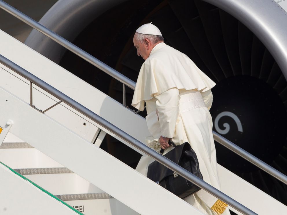 PHOTO:Pope Francis carries his work bag in Romes Fiumicino International airport, July 5, 2015, as he boards his flight to Quito, Ecuador.