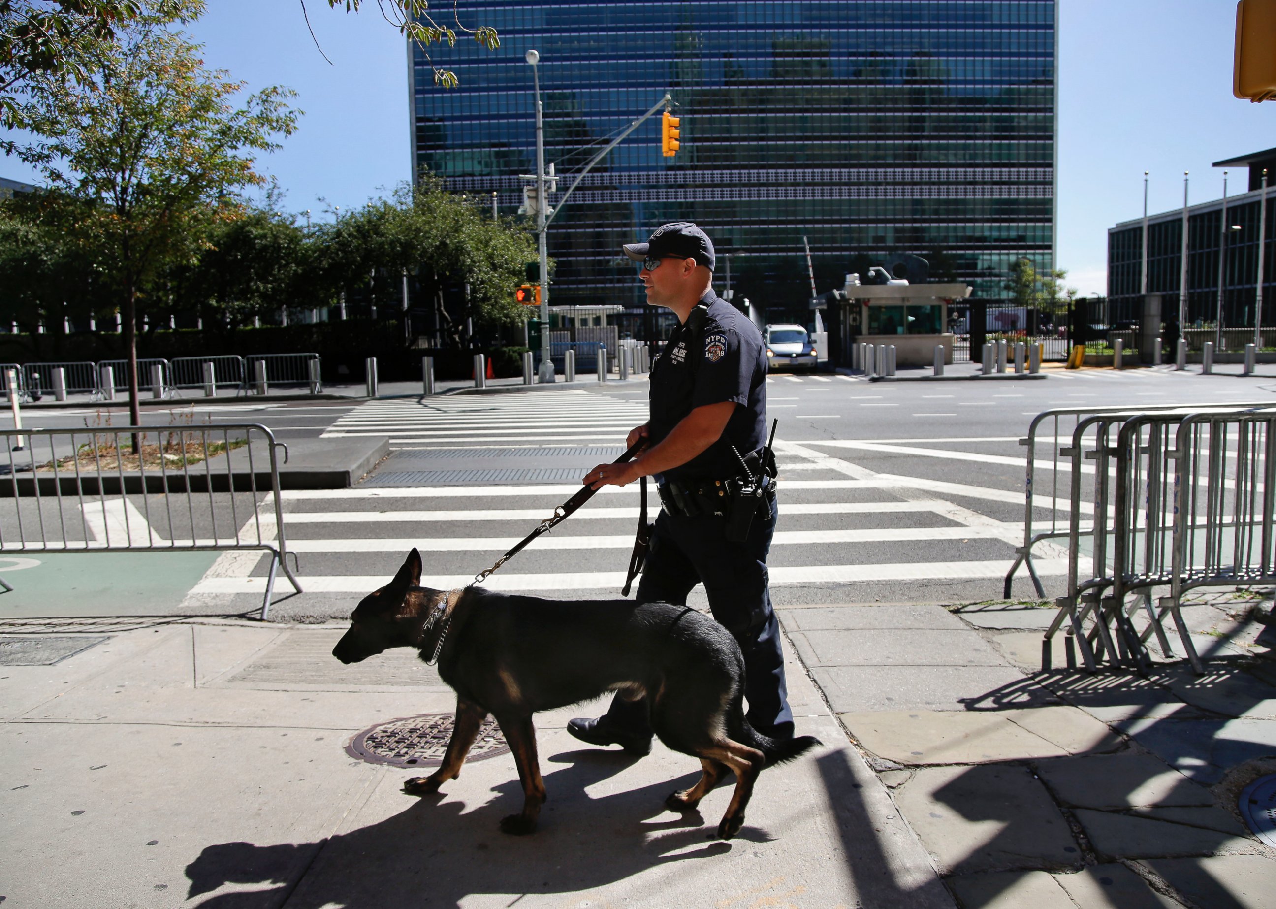 PHOTO: New York Police Department officer Chris Matz and his police dog, Clyde, walk along First Avenue across from the United Nations compound, Sept. 23, 2015, in New York. 