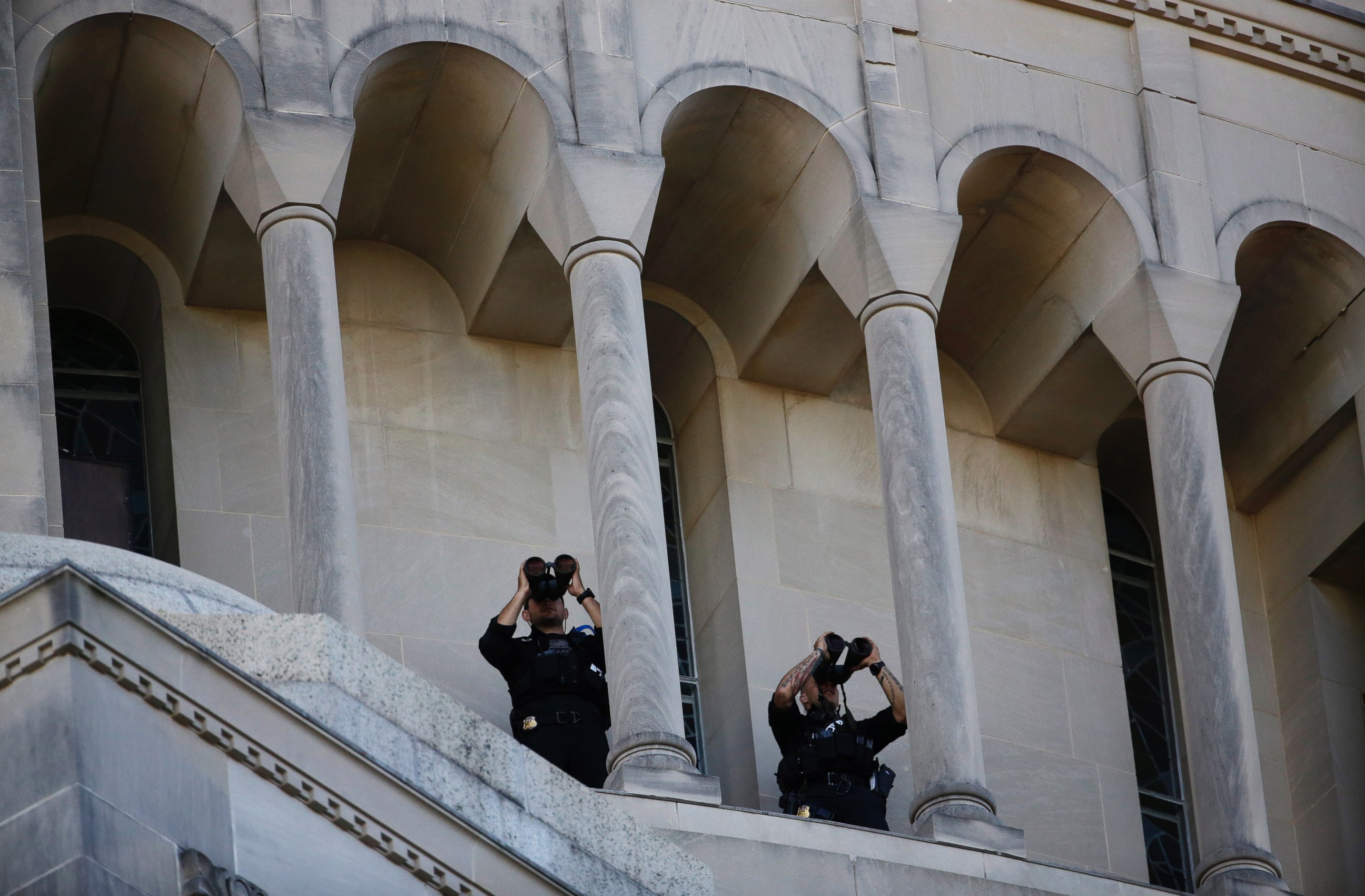 PHOTO: Security personnel look through binoculars during a Mass conducted by Pope Francis outside the Basilica of the National Shrine of the Immaculate Conception, Sept. 23, 2015, in Washington.