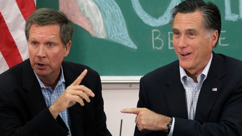 In this file photo, Mitt Romney and  John Kasich point to each other during a roundtable discussion with students at Otterbein University in Westerville, Ohio, April 27, 2012. 