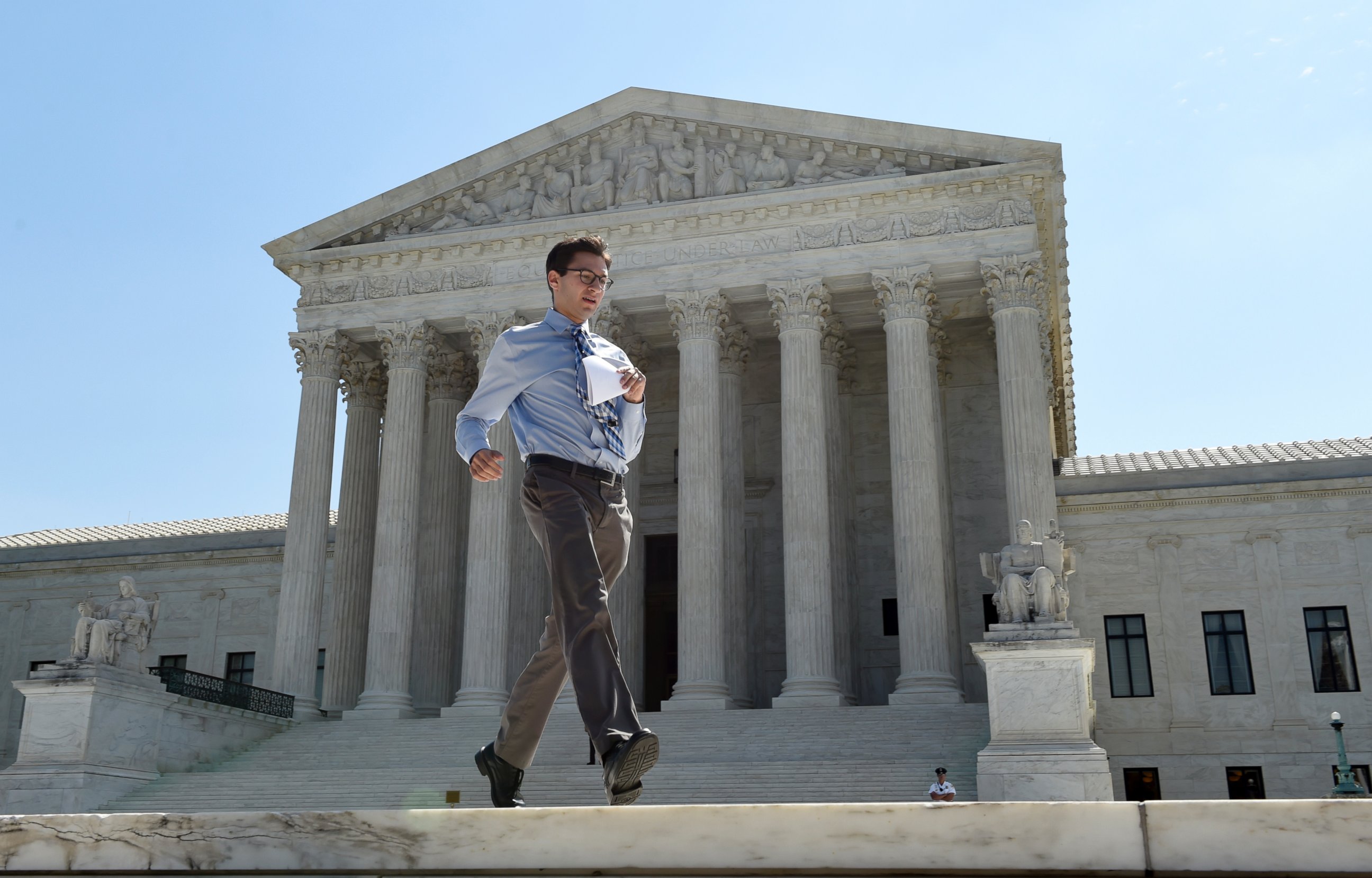 PHOTO:Intern Sam Gringlas runs with one of the Supreme Court rulings in his hand in front of the Supreme Court, June 22, 2015, in Washington.