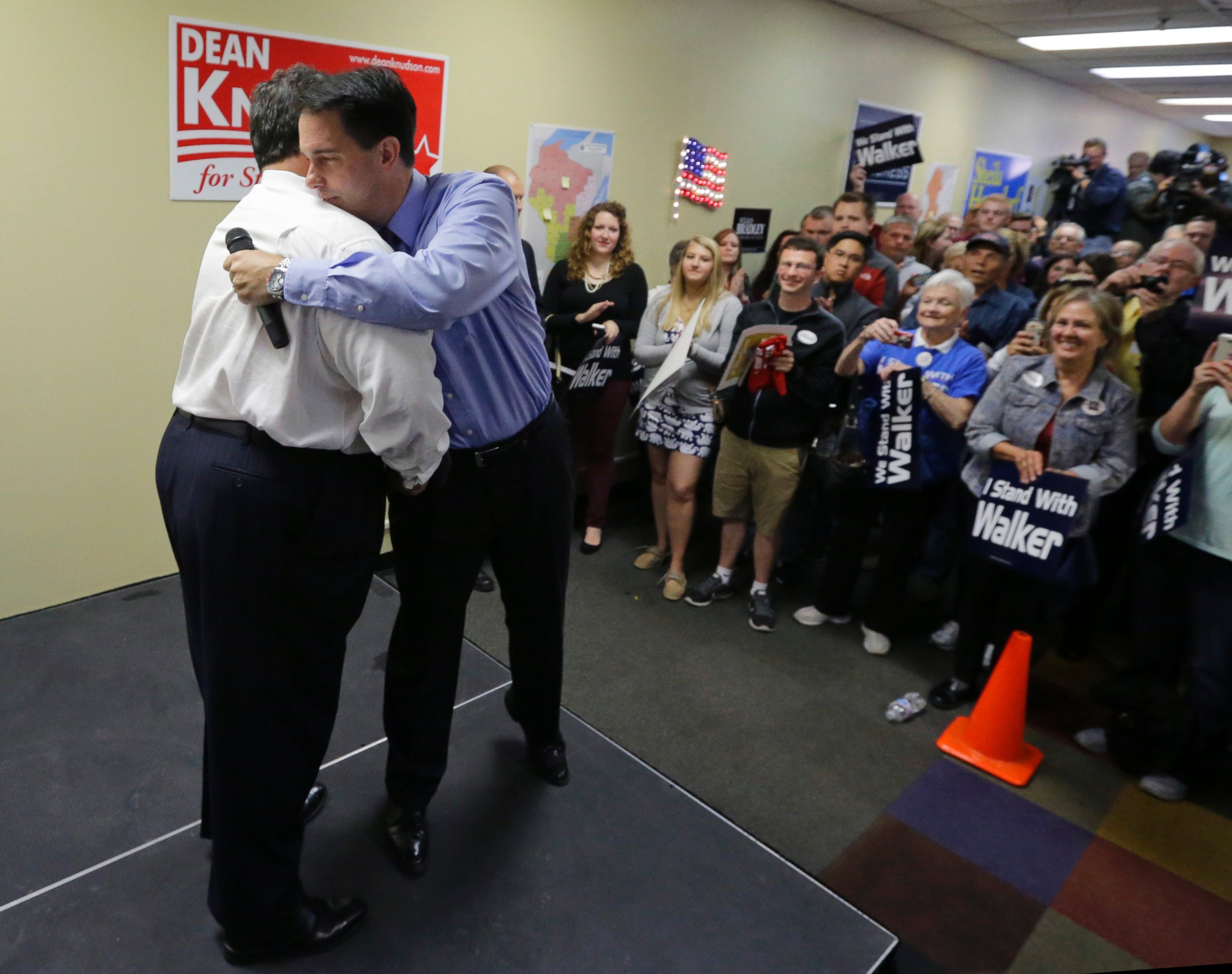 PHOTO: Wisconsin Gov. Scott Walker embraces New Jersey Gov. Chris Christie, left, at a campaign event for Walker at the Republican field office in Hudson, Wis., Monday, Sept. 29, 2014. 