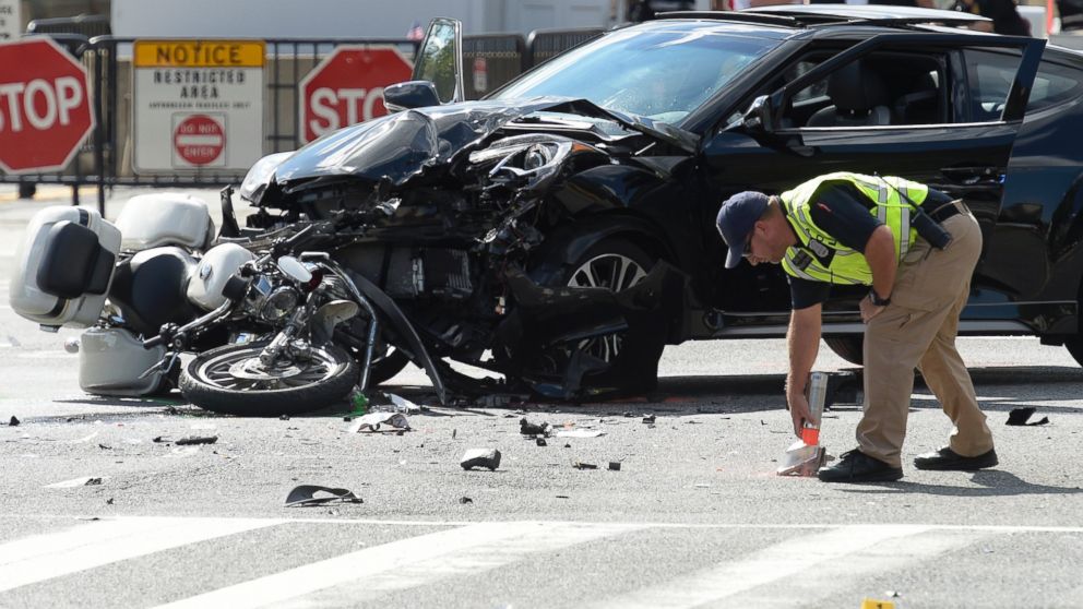 An investigator marks the accident area where a U.S. Secret Service uniformed division motorcycle officer was struck by a car near the White House in Washington, Sept. 12, 2016. 
