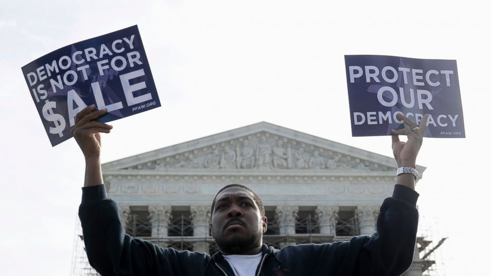 PHOTO: Cornell Woolridge of Windsor Mill, Md., takes part in a demonstration outside the Supreme Court in Washington as the court heard arguments on campaign finance. 