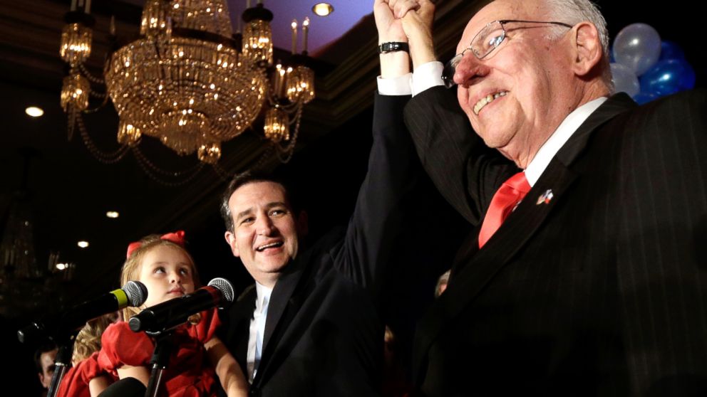 Republican candidate for U.S. Senate Ted Cruz, left, raises his hand with his father Rafael, right, while holding his daughter Caroline during a victory speech, Nov. 6, 2012, in Houston.