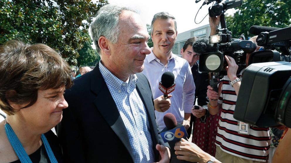 PHOTO: Senator Tim Kaine, center, with his wife Anne Holton, answers questions after attending Mass at their church, St. Elizabeth Catholic Church, in Richmond, Va., July 24, 2016.
