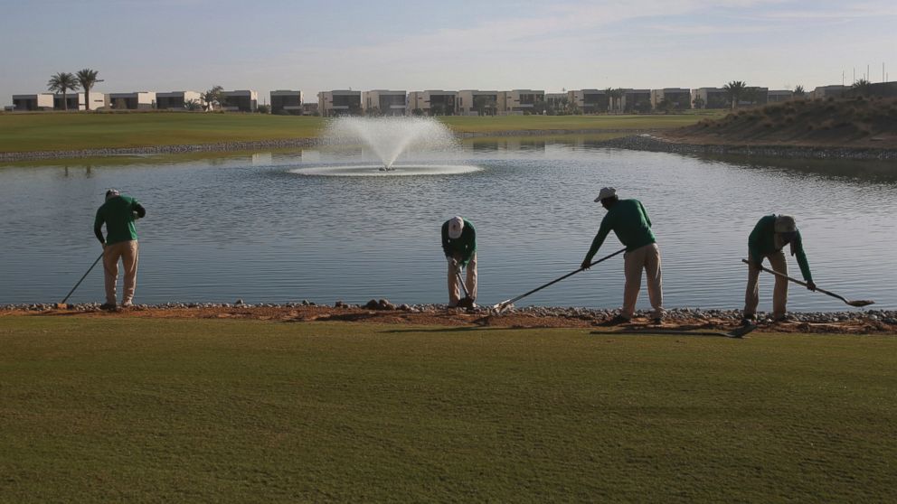 PHOTO: Gardeners put the final touches on greens at the Trump International Golf Club, in Dubai, United Arab Emirates, Dec. 20, 2016.