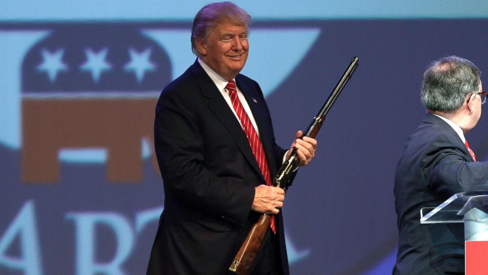 Donald Trump holds a Henry repeating rifle that was presented to him after speaking at the Republican Party of Arkansas Reagan Rockefeller dinner in Hot Springs, Ark., July 17, 2015.