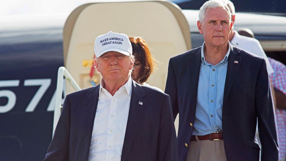Republican presidential candidate Donald Trump, followed by his running mate, Indiana Gov. Mike Pence, emerges from his plane as he arrives to tour the flood damaged city of Baton Rouge, La., Aug. 19, 2016.