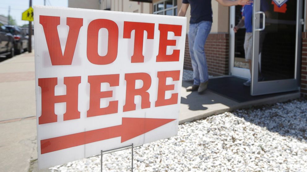 A man leaves an early voting poling place in Lonoke, Ark., May 5, 2014.