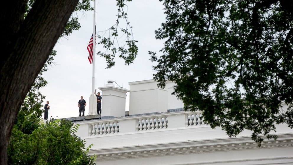 The American flag is lowered to half staff above the White House in Washington,  July 21, 2015, to honor the five U.S. service members who were killed by a gunman in Chattanooga, Tenn. last week. 