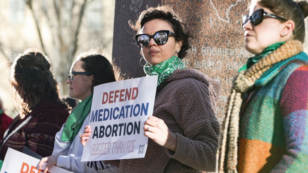 PHOTO: Lindsay London holds protest sign in front of federal court building in support of access to abortion medication outside the Federal Courthouse, March 15, 2023, in Amarillo, Texas.