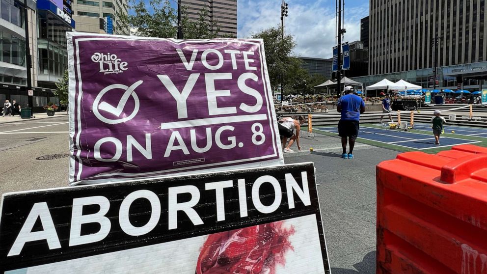 PHOTO: A sign asking Ohioans to vote in favor of Issue 1 sits above another sign in support of abortion rights at an event organized by Created Equal, July 20, 2023, in Cincinnati.