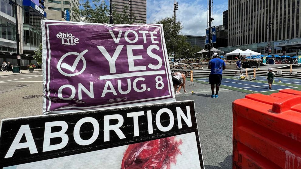 PHOTO: A sign asking Ohioans to vote in support of Issue 1 sits above another sign advocating against abortion rights at an event hosted by Created Equal, July 20, 2023, in Cincinnati.