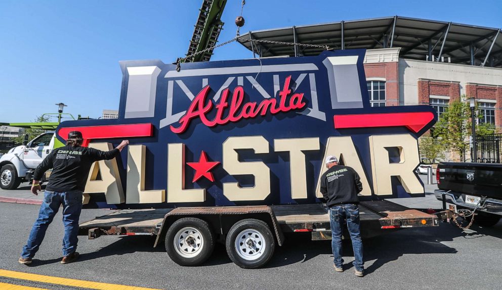 Workers load an All-Star sign onto a trailer after it was removed from Truist Park in Atlanta on Tuesday, April 6, 2021. Major League Baseball plans to relocate the All-Star Game over objections to sweeping changes to Georgia's voting laws.