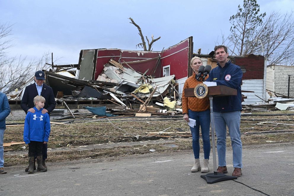 PHOTO: President Joe Biden stands with Dane Maddox, 7, Kentucky Governor Andy Beshear speaks next to Kentucky First Lady Britainy Beshear after touring storm damage in Dawson Springs, Ky., Dec. 15, 2021.