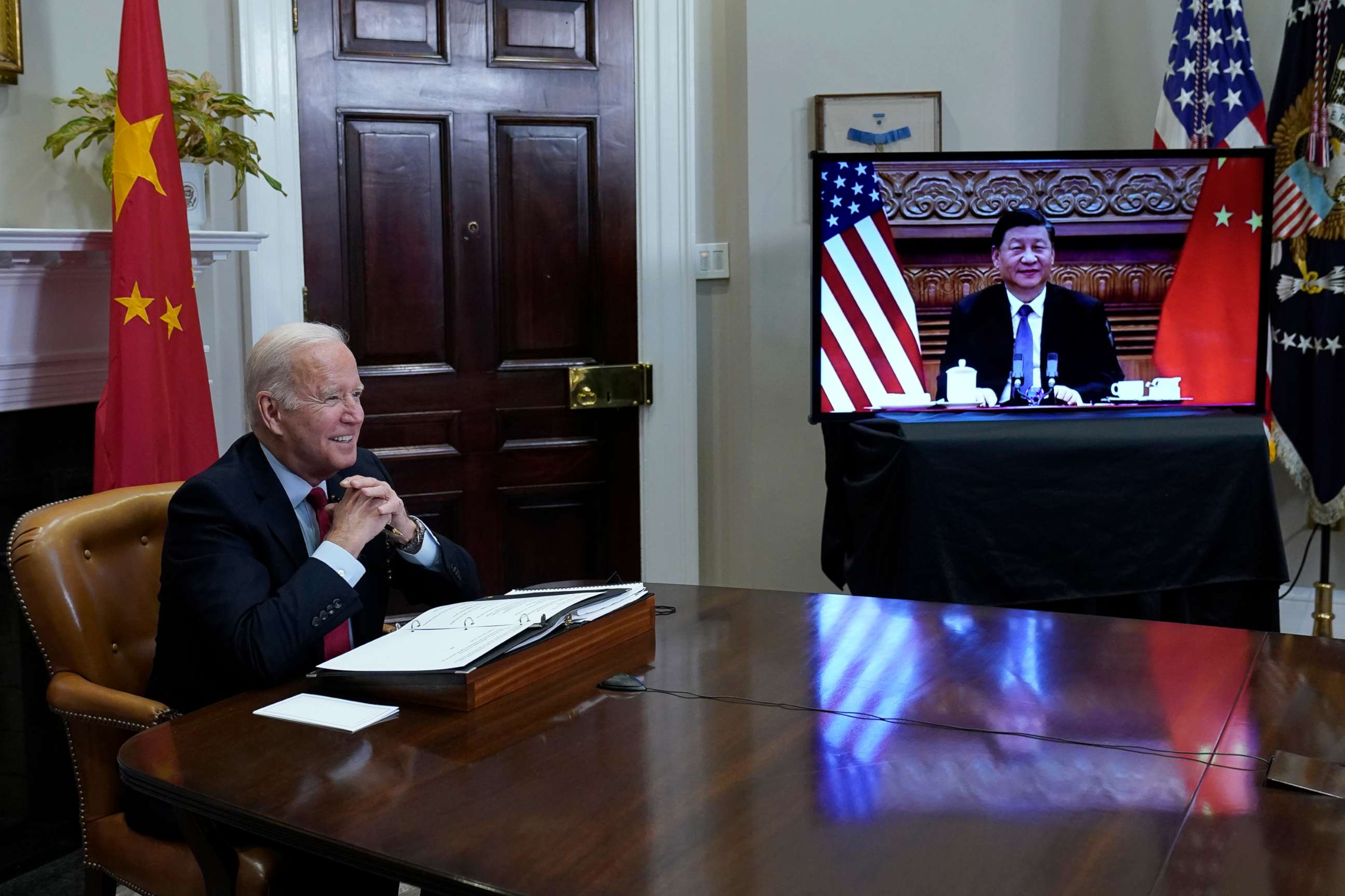 PHOTO: President Joe Biden, left, speaks as he meets virtually with Chinese President Xi Jinping, on screen, from the Roosevelt Room of the White House, Nov. 15, 2021.