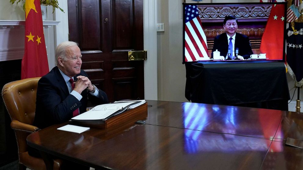 PHOTO: President Joe Biden, left, speaks as he meets virtually with Chinese President Xi Jinping, on screen, from the Roosevelt Room of the White House, Nov. 15, 2021.