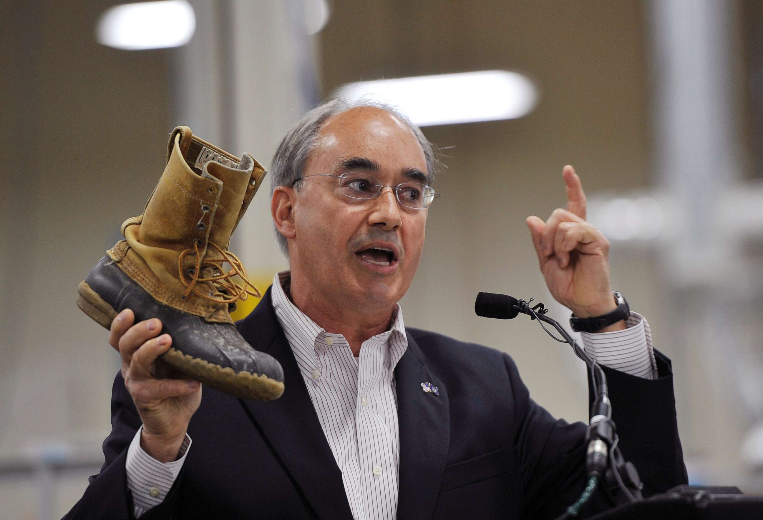 PHOTO: Rep. Bruce Poliquin shows of his thirty-year-old L.L. Bean boots during an event at the new production plant in Lewiston, Maine, August 17, 2017.