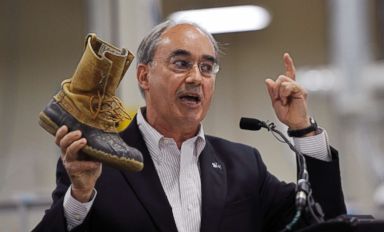 PHOTO: Rep. Bruce Poliquin shows of his thirty-year-old L.L. Bean boots during an event at the new production plant in Lewiston, Maine, August 17, 2017.