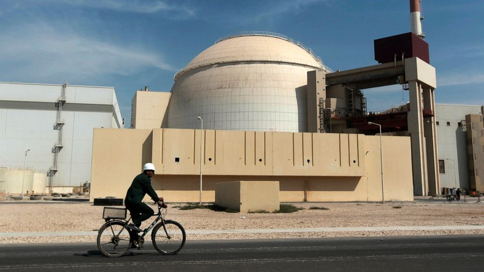PHOTO: A worker rides a bicycle in front of the reactor building of the Bushehr nuclear power plant, just outside the southern city of Bushehr, Iran, Oct. 26, 2010. 