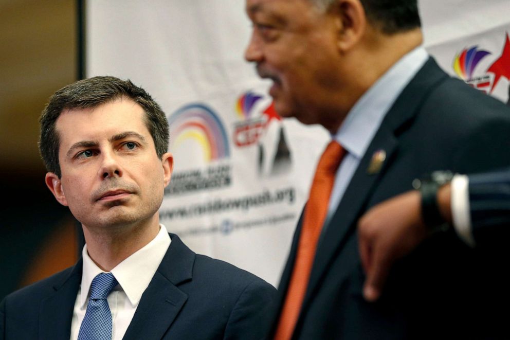 PHOTO:Democratic presidential candidate and South Bend, Ind., Mayor Pete Buttigieg, left, listens as Rev. Jesse Jackson addresses reporters during a news conference at the Rainbow PUSH Coalition Annual International Convention in Chicago, July 2, 2019.