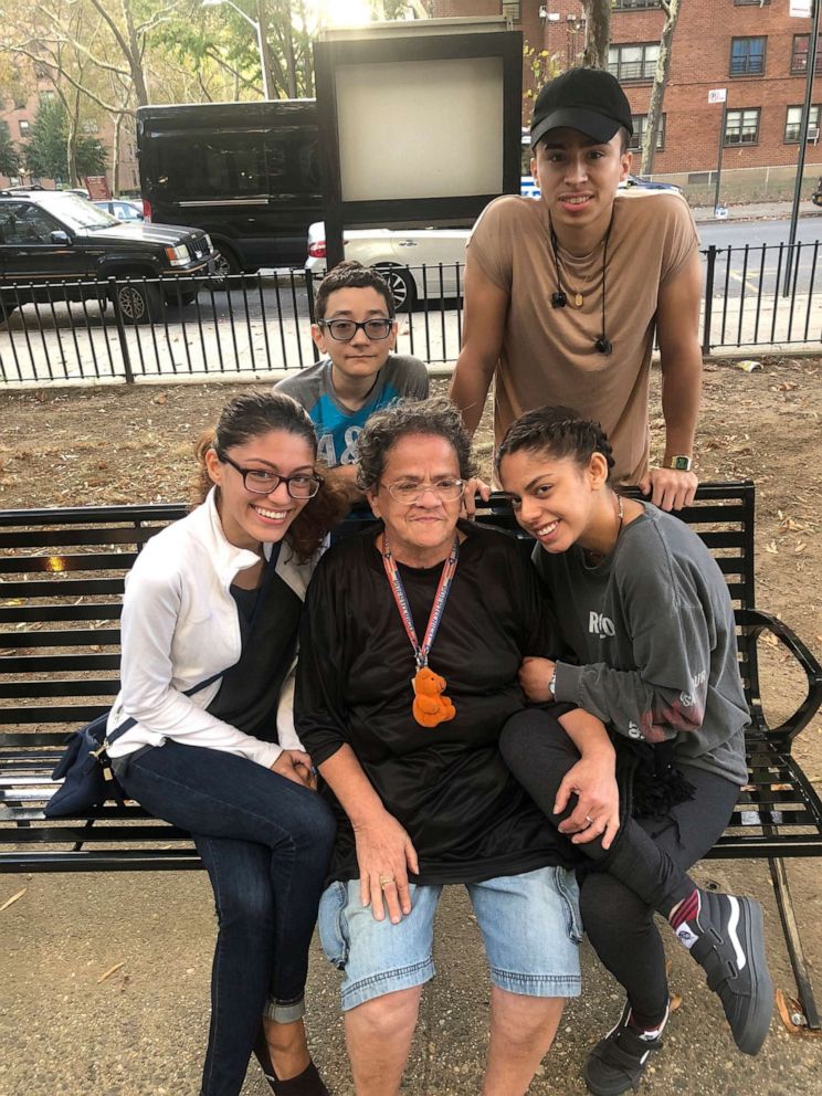 PHOTO: This 2018 photo provided by Peter Caballero shows Caballero's mother, Juanita Caballero, seated center, with her four grandchildren outside her apartment building in the Brooklyn borough of New York. 