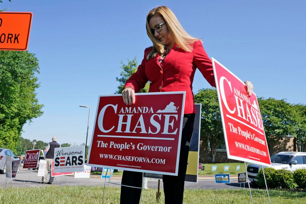 PHOTO: Republican gubernatorial candidate State Sen. Amanda Chase, places a yard sign during a drive through GOP Convention vote in Chesterfield, Va., May 8, 2021.