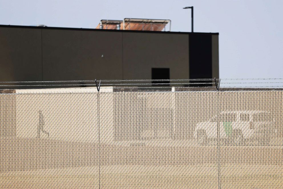 PHOTO: A person walks behind the fence at the Border Patrol station where lawyers reported that detained migrant children had been held unbathed and hungry on June 26, 2019 in Clint, Texas.