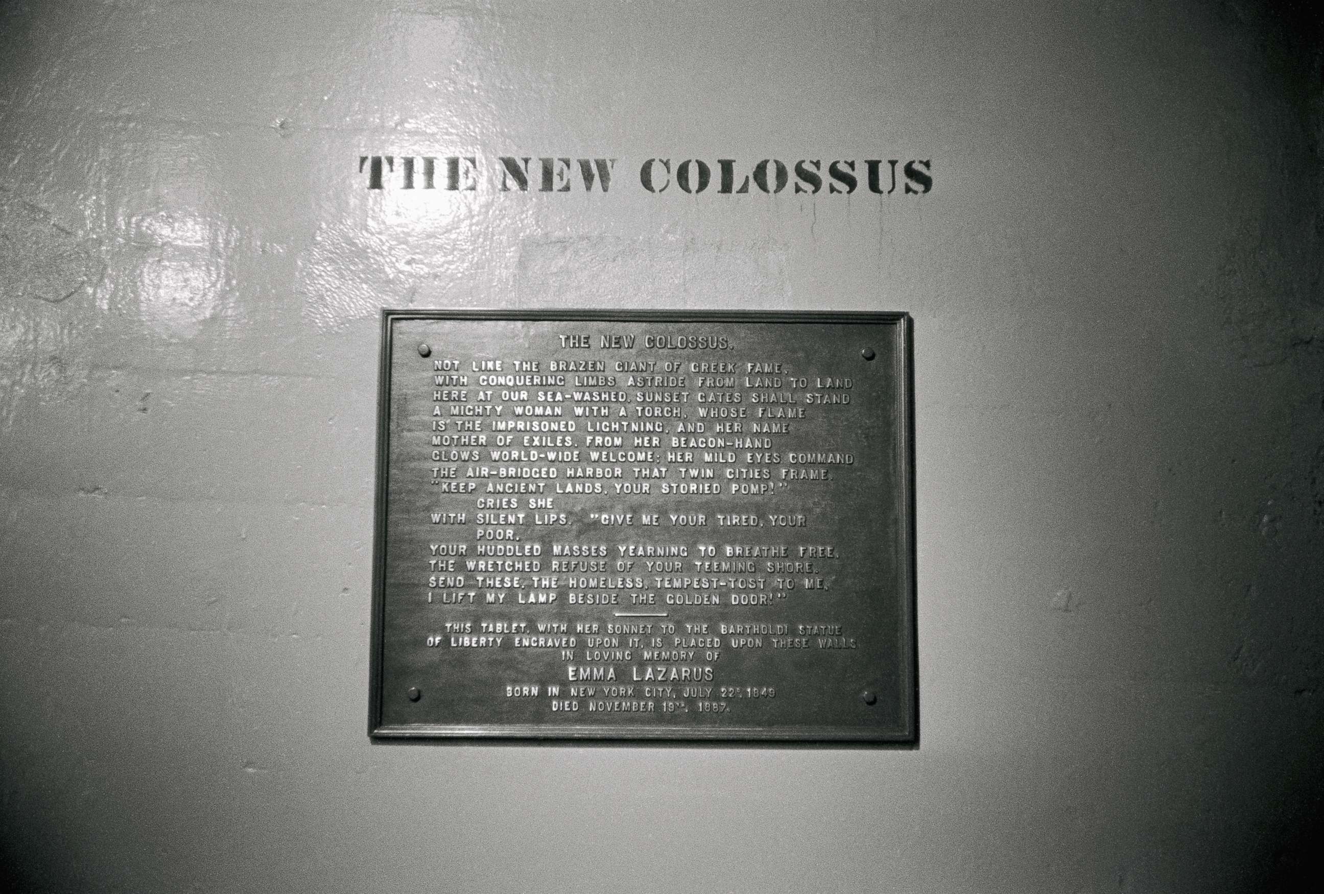 PHOTO: A plaque with a poem entitled "The New Colossus" by Emma Lazarus located on the base of the Statue of Liberty.