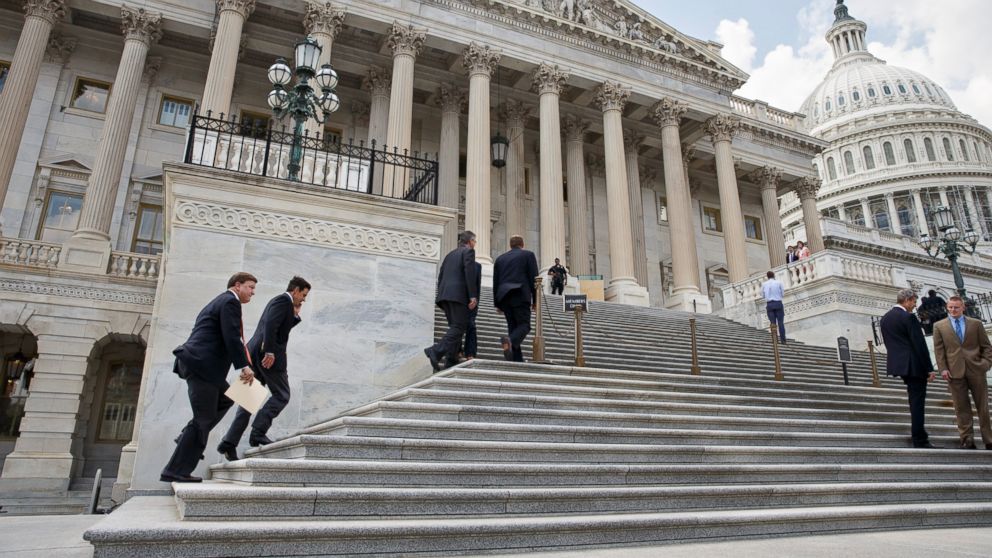 PHOTO: Members Congress clinb the steps of the House of Representatives for final votes, at the Capitol in Washington, Thursday, July 31, 2014.