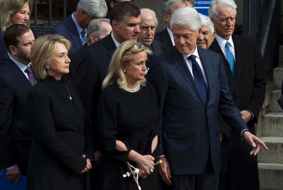 PHOTO: Rep. Debbie Dingell, D-Mich., center, accompanied by former President Bill Clinton and former first lady Hillary Clinton, watch the flag-draped casket of former Rep. John Dingell at Holy Trinity Catholic Church, Feb. 14, 2019, in Washington D.C.