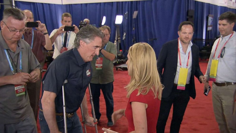 PHOTO: Gov. Doug Burgum a Republican presidential candidate walks on crutches at the first Republican Presidential primary debate at the Fiserv Forum in Milwaukee, Aug. 23, 2023.