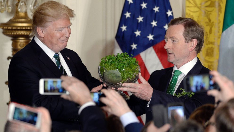 PHOTO: President Donald Trump, accepts a bowl of shamrocks from Enda Kenny, Ireland's prime minister during a reception in the East Room of the White House in Washington, March 16, 2017. 