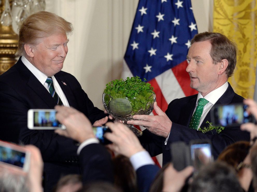 PHOTO: President Donald Trump, accepts a bowl of shamrocks from Enda Kenny, Irelands prime minister during a reception in the East Room of the White House in Washington, March 16, 2017.