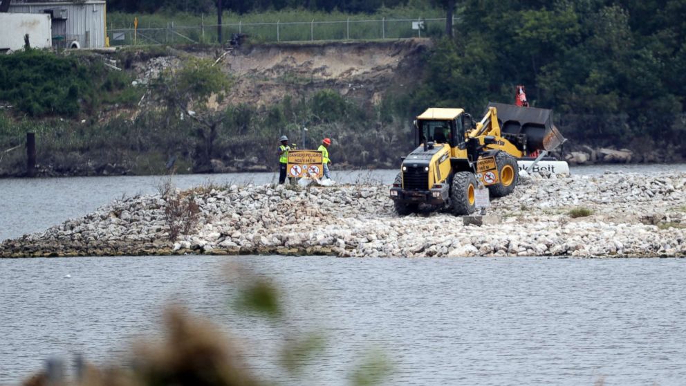 PHOTO: Workers are shown at San Jacinto River Waste Pits in Channelview, Texas, Sept. 13, 2017..  The EPA says an unknown amount of a dangerous chemicals may have washed downriver from this Superfund site during the flooding from Hurricane Harvey.  