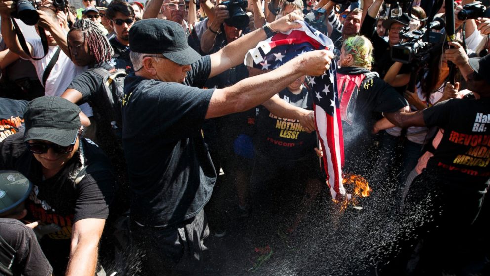 A protestor burns a US flag near the entrance to Quicken Loans Arena, site of the Republican National Convention, in Cleveland, Ohio, July 20, 2016.