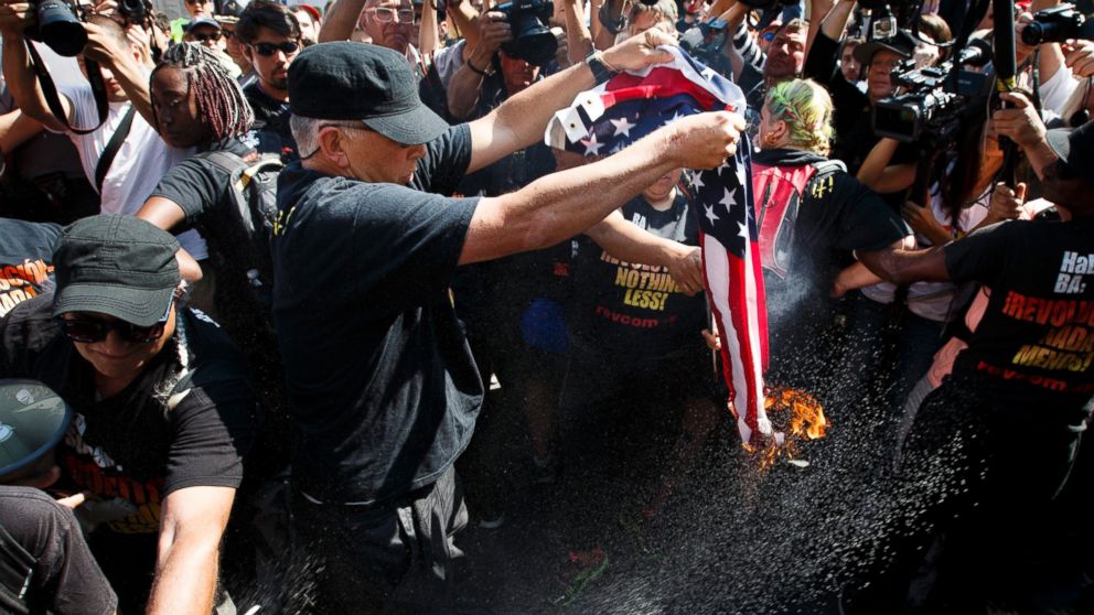 A protestor burns a US flag near the entrance to Quicken Loans Arena, site of the Republican National Convention, in Cleveland, Ohio, July 20, 2016.