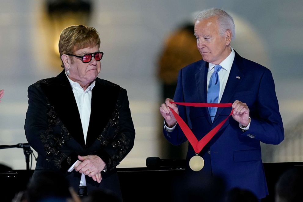 PHOTO: President Joe Biden presents Elton John with the National Humanities Medal after a concert on the South Lawn of the White House in Washington, Friday, Sept. 23, 2022. (AP Photo/Susan Walsh)
