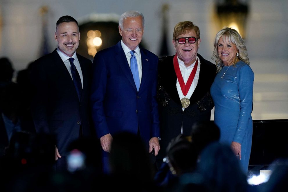 PHOTO: David Furnish, husband of Elton John, left, Elton John, President Joe Biden and first lady Jill Biden pose for a photo after Biden presented Elton John with a National Humanities Medal after a concert on the South Lawn of the White House