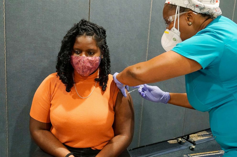 PHOTO: Nurse Helene Leger gives FIorida International University student Vanessa Claude, her first dose of the Pfizer COVID-19 shot at a vaccination site on campus, Aug. 24, 2021, in Miami. 