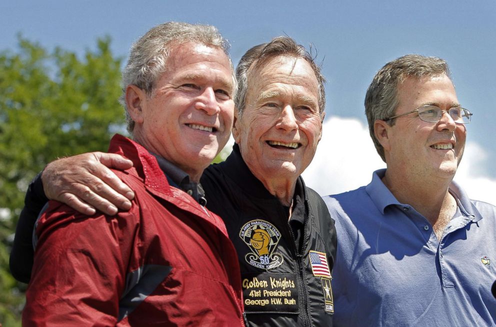 PHOTO: Former President George H. W. Bush poses with his sons, former President George W. Bush and Jeb Bush after completing a parachute jump in Kennebunkport, June 12, 2009 for his 85th birthday.