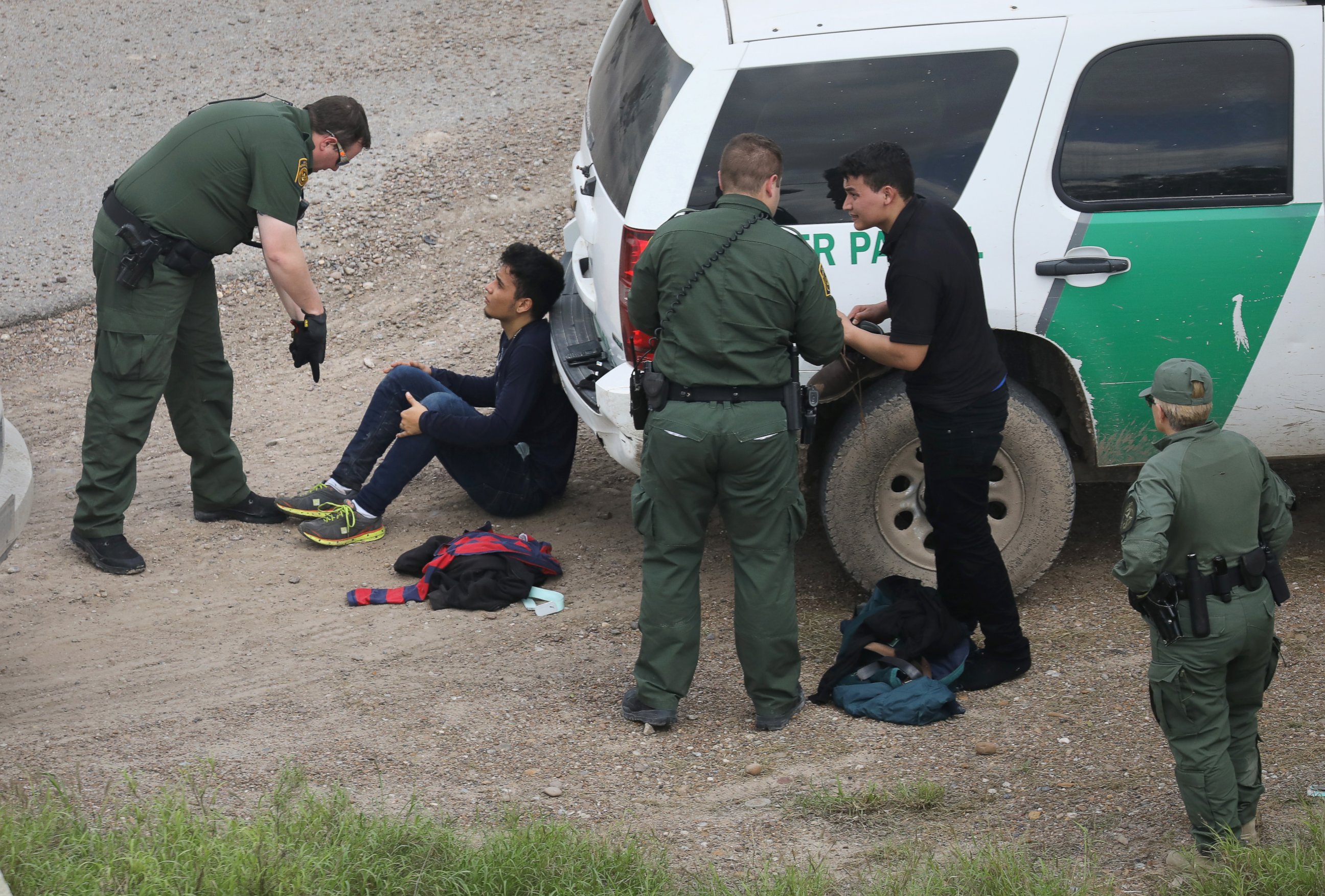 PHOTO: U.S. Border Patrol agents detain two undocumented immigrants after capturing them near the U.S. and Mexico border, on March 15, 2017, near McAllen, Texas. 