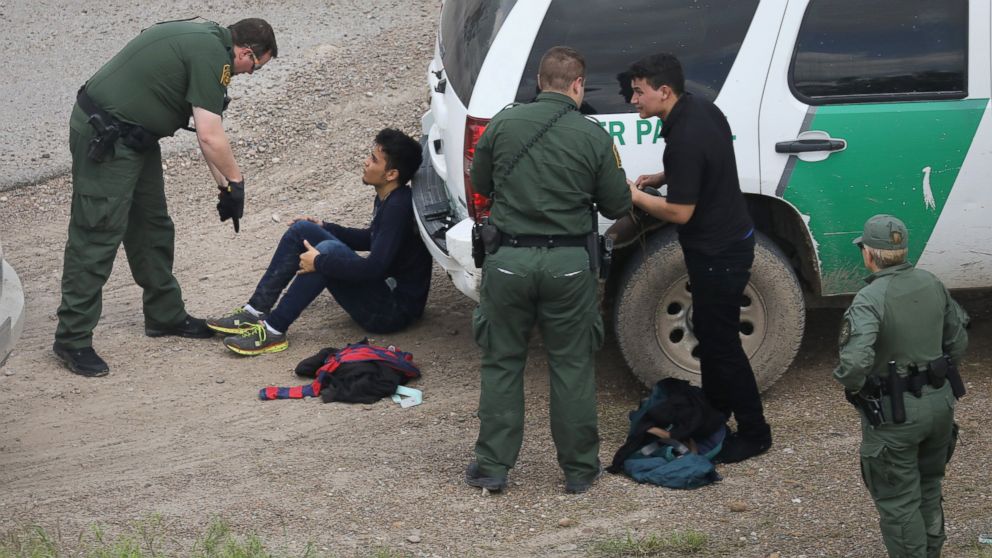 PHOTO: U.S. Border Patrol agents detain two undocumented immigrants after capturing them near the U.S. and Mexico border, on March 15, 2017, near McAllen, Texas.