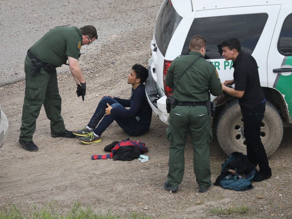 PHOTO: U.S. Border Patrol agents detain two undocumented immigrants after capturing them near the U.S. and Mexico border, on March 15, 2017, near McAllen, Texas.
