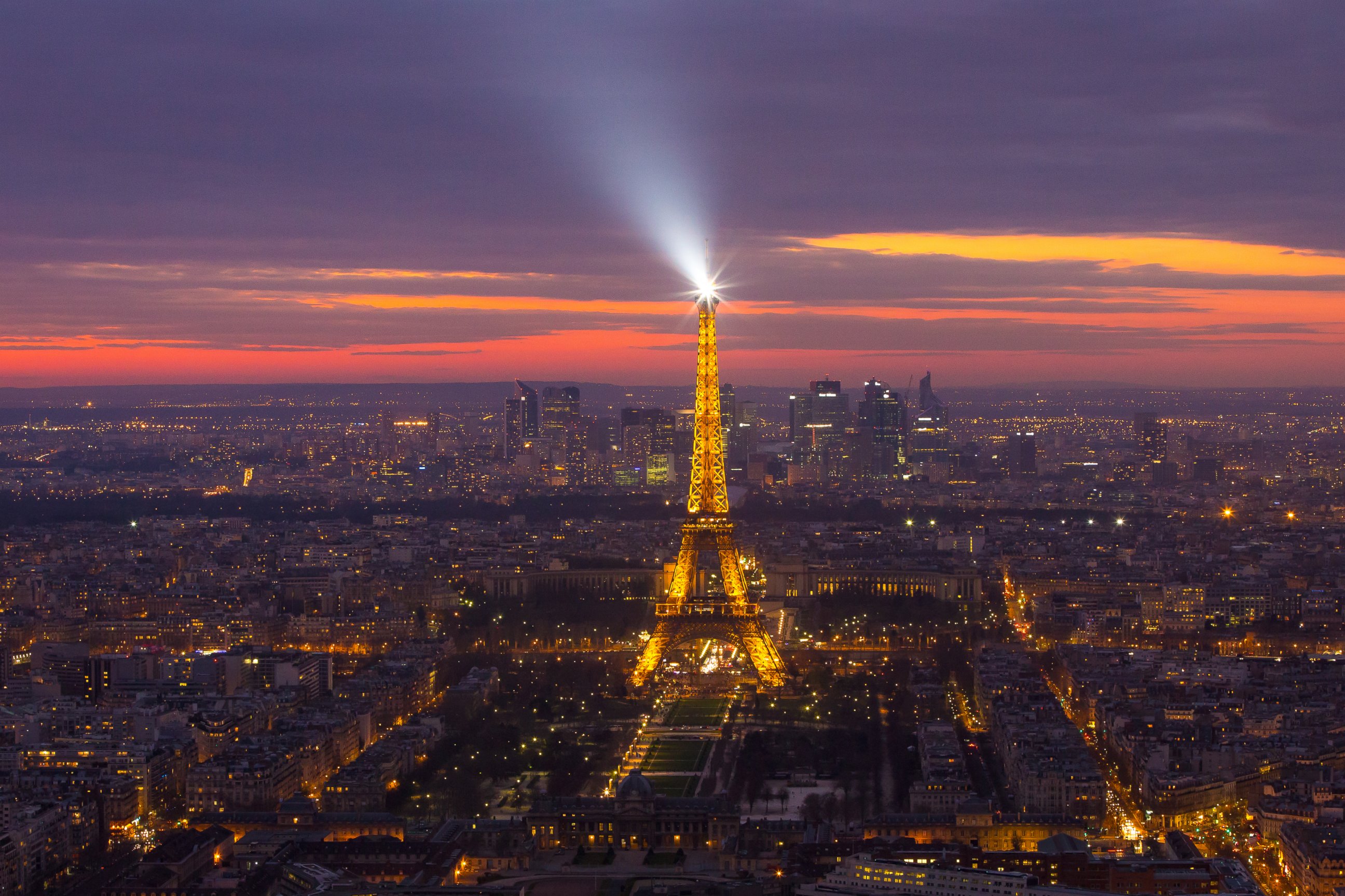 PHOTO: The Eiffel tower shining its spotlight just after sunset, March 16, 2014, in Paris.