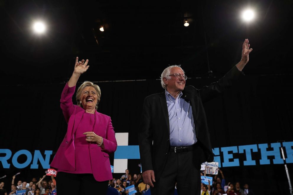 PHOTO: Democratic presidential nominee Hillary Clinton and Sen Bernie Sanders greet supporters during a campaign rally at Coastal Credit Union Music Park at Walnut Creek, Nov. 3, 2016, in Raleigh, North Carolina. 